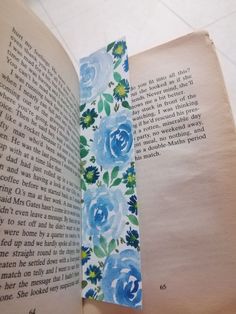 an open book with blue flowers on it