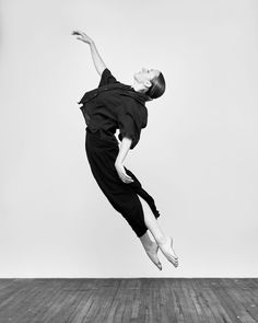 a person jumping in the air on a wooden floor