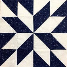 a blue and white quilted star with polka dots