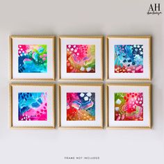 four colorful paintings hanging on the wall in a room with white walls and gold frames