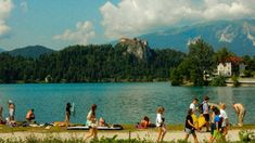 many people are on the shore of a lake