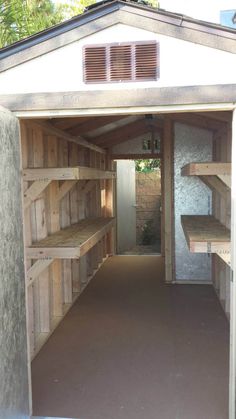 the inside of a storage shed with shelves