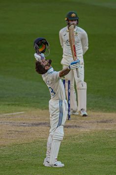 a man holding a baseball bat on top of a field