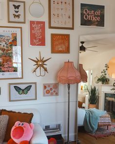 a living room filled with furniture and pictures on the wall