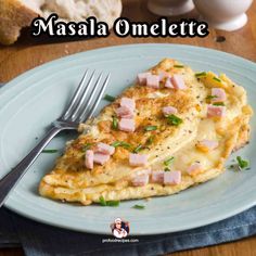 an omelette with ham is on a blue plate