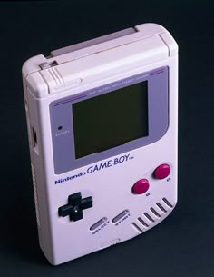 an old nintendo game boy toy sitting on top of a table