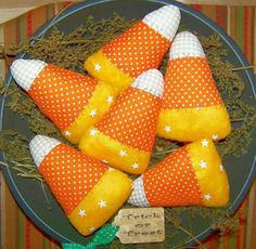 orange and white candy cones are on a plate