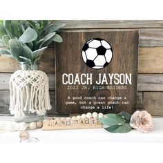 a wooden sign with a soccer ball on it