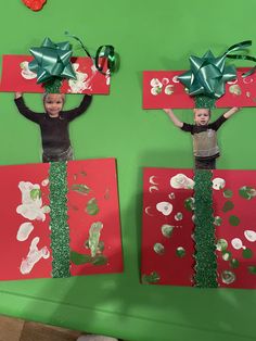 two children wearing green bows on top of red and green paper with silver confetti