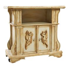 an antique white cabinet with carvings on the doors and drawers is isolated against a white background