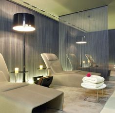 a living room filled with lots of furniture next to a wall covered in sheer curtains