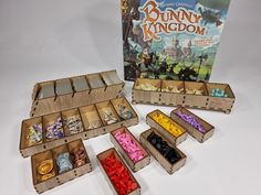 an open wooden box filled with lots of different colored beads next to a board game