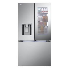 a silver refrigerator freezer sitting inside of a glass doored cabinet with drinks in it