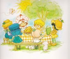 children are sitting at a picnic table with books