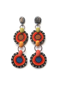 the earrings are decorated with beads and beading on top of each other, including two circles