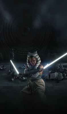 a woman with two lights sabers in her hand