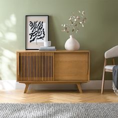 a living room scene with focus on the sideboard and chair in the foreground