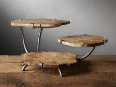 two tiered wooden table with metal legs on top of a piece of drift wood