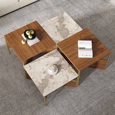 three tables with marble top and wooden legs in a living room or dining area, one on the floor