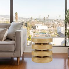 a living room with a couch, chair and table in front of a large window