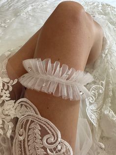 Introducing our Bespoke and Minimalist Bridal Garter with Small European Crystals.    This crystal adjourned Garter is all about comfort and style. Crafted from stretchy tulle, it's designed to fit you perfectly, ensuring you're at ease as you dance the night away.  Each crystal is hand-placed to create a stunning and unique design. Crafted with love and attention to detail, this garter is more than an accessory - it's a cherished keepsake that captures the essence of your special day.  Why Choose Our Crystal Wedding Garter:  🌸 Uniquely Bespoke: Every crystal is delicately positioned, creating an exclusive design you won't find anywhere else. Your garter will be as special as your love story.  🌸 Perfect Bridal Gift: Searching for the ideal bridal gift? Look no further. Our tulle garter w Bridal Garter Crystal, Wedding Garter Plus Size, Tulle Garter, Bride Garter, Minimalistic Wedding, Bridal Garters, Wedding Garters, Bridal Garter, Wedding Garter