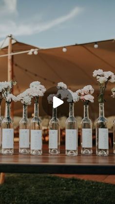 a table topped with lots of bottles filled with flowers