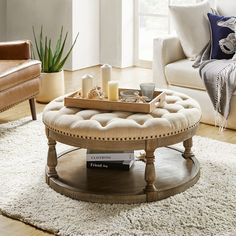 a living room with a couch, chair and coffee table in it's center