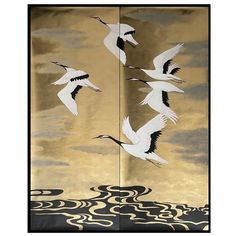 four cranes flying in the sky over water with waves and clouds behind them on a gold background