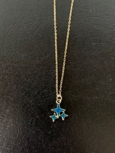 Dainty, attractive and unique gold tone and dark blue or dark turquoise blue polar stars necklace.   Pendant is small measuring 1/2" L X 1/2" W and is on an 18" chain.   ★ Want to see more?  Please visit my shop at: https://www.etsy.com/shop/DesignsByPeg Blue Star Charm Pendant Necklace, Blue Pendant Necklace With Star Charm, Blue Necklaces With Starfish Charm For Gifts, Blue Star Charm Jewelry As Gift, Blue Star Charm Necklace As A Gift, Blue Star Charm Jewelry, Blue Star Charm Necklace As Gift, Blue Star Charm Jewelry For Gift, Blue Star Charm Necklace For Gift