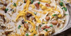 a casserole dish with chicken, beans and cheese