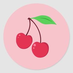 two cherries with green leaves on a pink round sticker that says, cherry