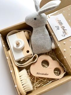 a wooden toy rabbit sitting inside of a cardboard box with other items in it's packaging