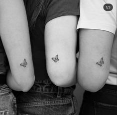 three people with small tattoos on their arms