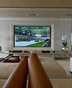 a large flat screen tv mounted to the side of a wall in a living room