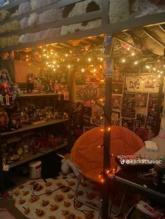 a room filled with lots of halloween decorations and lights on the ceiling above it is a bed covered in pumpkins