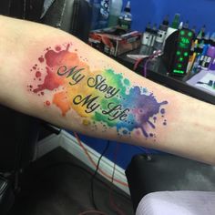 a watercolor tattoo with the words my story is my life painted on it's arm