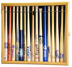 a wooden box filled with lots of different types of baseball bats on top of a white wall