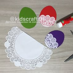 paper doilies and crochet laces laid out on a wooden table with markers