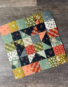 a patchwork quilt on top of a wooden table