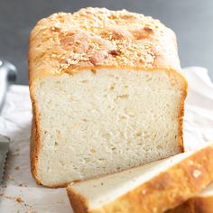 a loaf of bread sitting on top of a white paper towel next to a knife