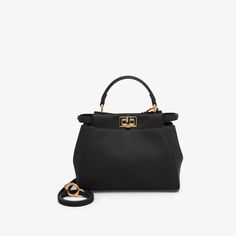 Iconic small Peekaboo bag made of soft black leather and embellished with the classic twist lock on both sides. Features a tone on tone nappa leather lining with two compartments separated by a stiff partition, an inner zip pocket and gold-finish metalware. The bag can be carried by hand or worn either on the shoulder or cross-body thanks to the handle and adjustable, detachable shoulder strap. Made in Italy. One Size Fendi Peekaboo Mini, Fendi Peekaboo Bag, Peekaboo Bag, Fendi Logo Design, Fendi Store, Fendi Peekaboo, Fendi Logo, Black Leather Bags, Exclusive Gift