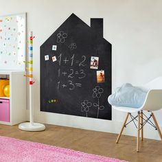 a child's room with a chalkboard and toys