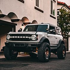 a white truck parked in front of a building