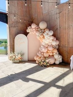 an arch made out of balloons and flowers