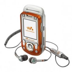 an orange and white cell phone with ear buds