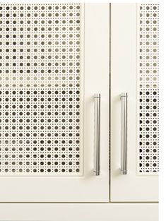 a white cabinet with two doors and metal handles