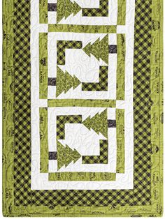 a green and white quilt with an arrow pattern on it, in the shape of two rectangles