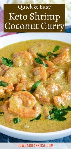 a white bowl filled with shrimp curry and garnished with spinach on top