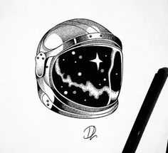 a drawing of an astronaut's helmet with stars in the sky on paper next to a pen