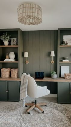 a home office with built - in shelving units and a rug on the floor